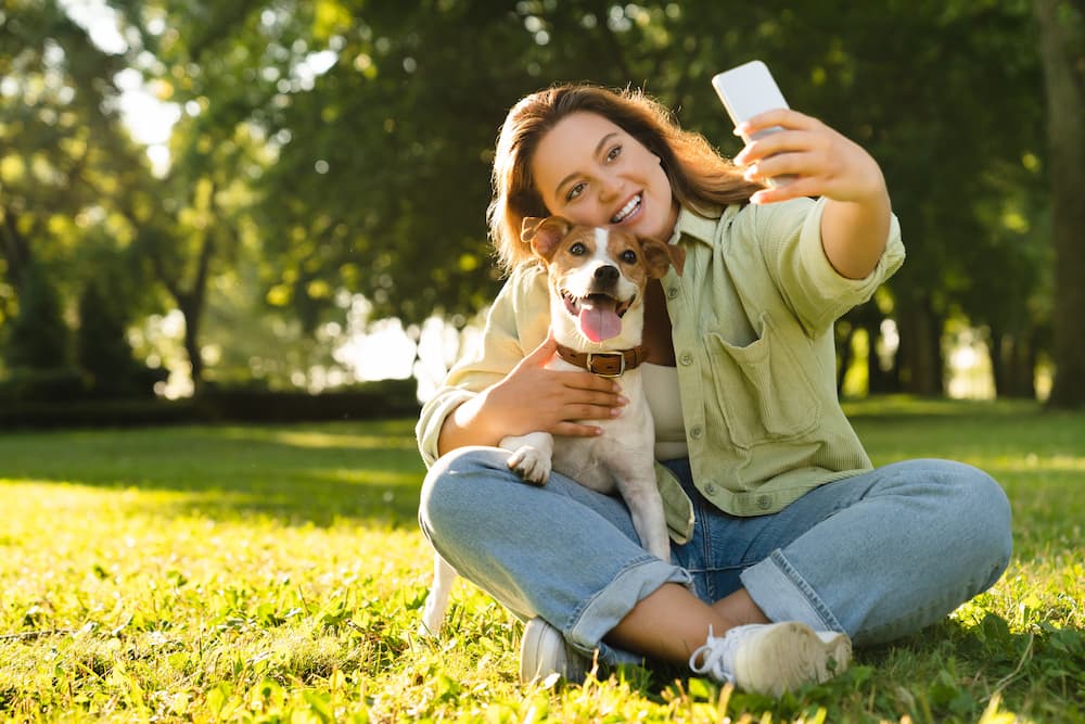 Pet Owner or Pet Sitter taking selfie photo with dog